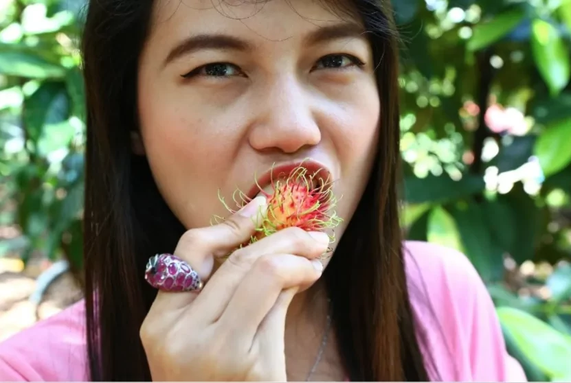 Asian girl eat Rambutan fruit in Vietnam Asian girl eat Rambutan fruit in Vietnam